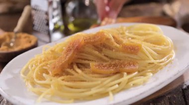Spaghetti with bottarga. Typical Sardinian Cuisine. A dish with traditional Italian pasta from the South, dried sardine roe, lemon and pasta. High quality 4k footage