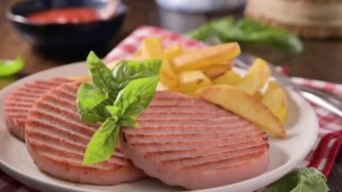 TENERONI WITH COOKED HAM.Soft Italian cutlets with prosciutto cotto, usually prepared for childrens meals and snacks. served with potatoes and vegetables .4k footage