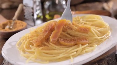 Spaghetti with bottarga. Typical Sardinian Cuisine. A dish with traditional Italian pasta from the South, dried sardine roe, lemon and pasta. High quality 4k footage