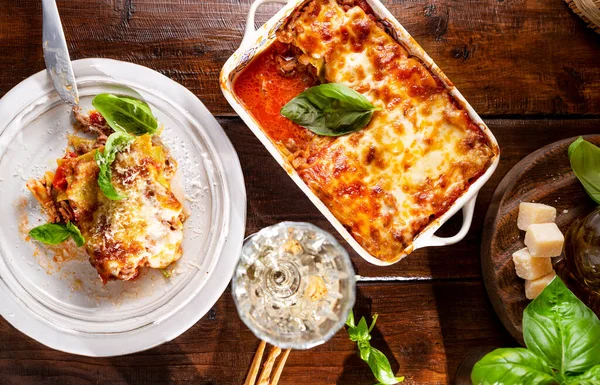 Lasagna with pesto.Italian lunch,homemade green lasagna with spinach in the dough, ragu - meat sauce, bechamel and parmesan cheese. illage dining atmosphere in Italy. Above