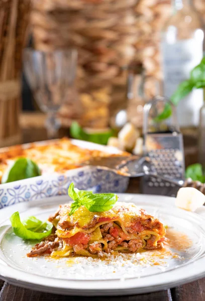 Lasagna with pesto.Italian lunch,homemade green lasagna with spinach in the dough, ragu - meat sauce, bechamel and parmesan cheese. illage dining atmosphere in Italy. Copy space