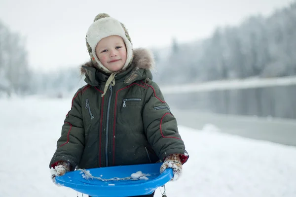 Portrait boy with sleigh in winter time — Stock Photo, Image