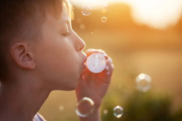 Kid Blowing Soap Bubbles Sunset Summer Day Boy Playing Nature — Stock Photo, Image