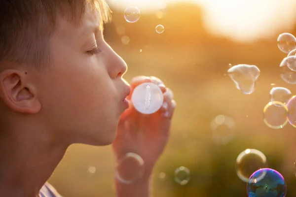 Kid Blowing Soap Bubbles Sunset Summer Day Boy Playing Nature — Stock Photo, Image