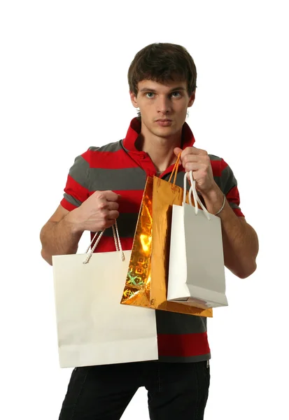 Joven sexy hombre sosteniendo bolsas de compras —  Fotos de Stock