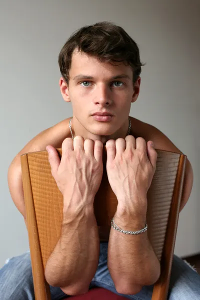 Sexy Man on the Wooden Chair — Stock Photo, Image