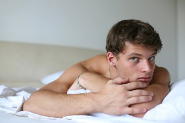 genç seksi bir adam bir yatakta