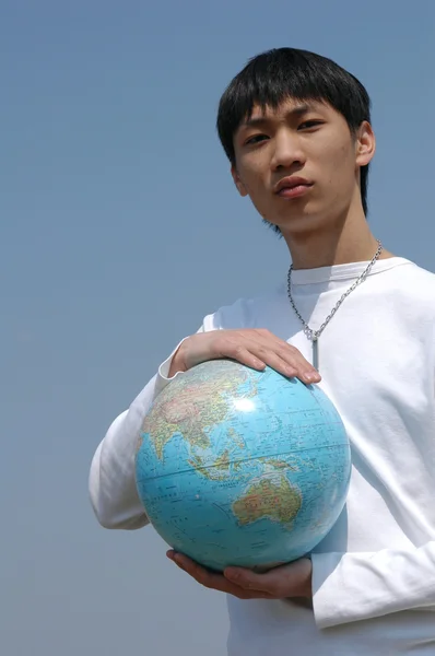 Jonge Aziatische man met een globe — Stockfoto