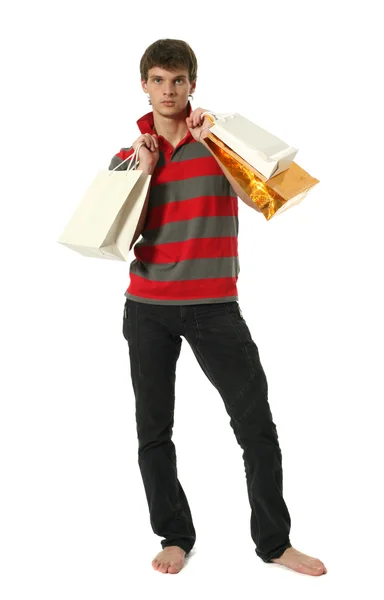 Jovem sexy homem com sacos de compras — Fotografia de Stock