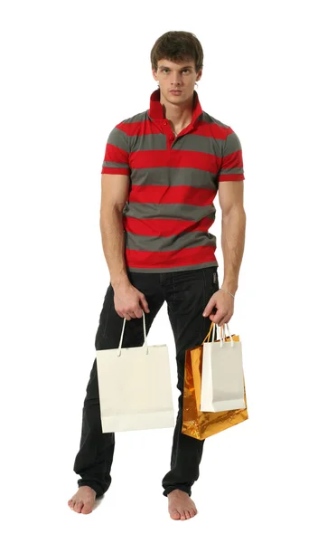 Młody seksowny mężczyzna z torby na zakupy — Zdjęcie stockowe