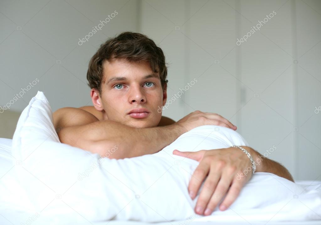 Sexy Man on the Bed Stock