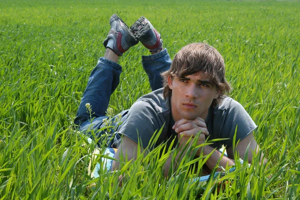 Sexy young man on green grass — Stock Photo, Image