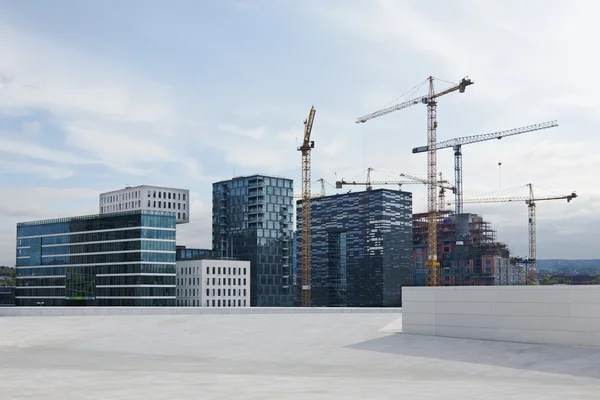 Modern buildings and cranes on duty — Stock Photo, Image