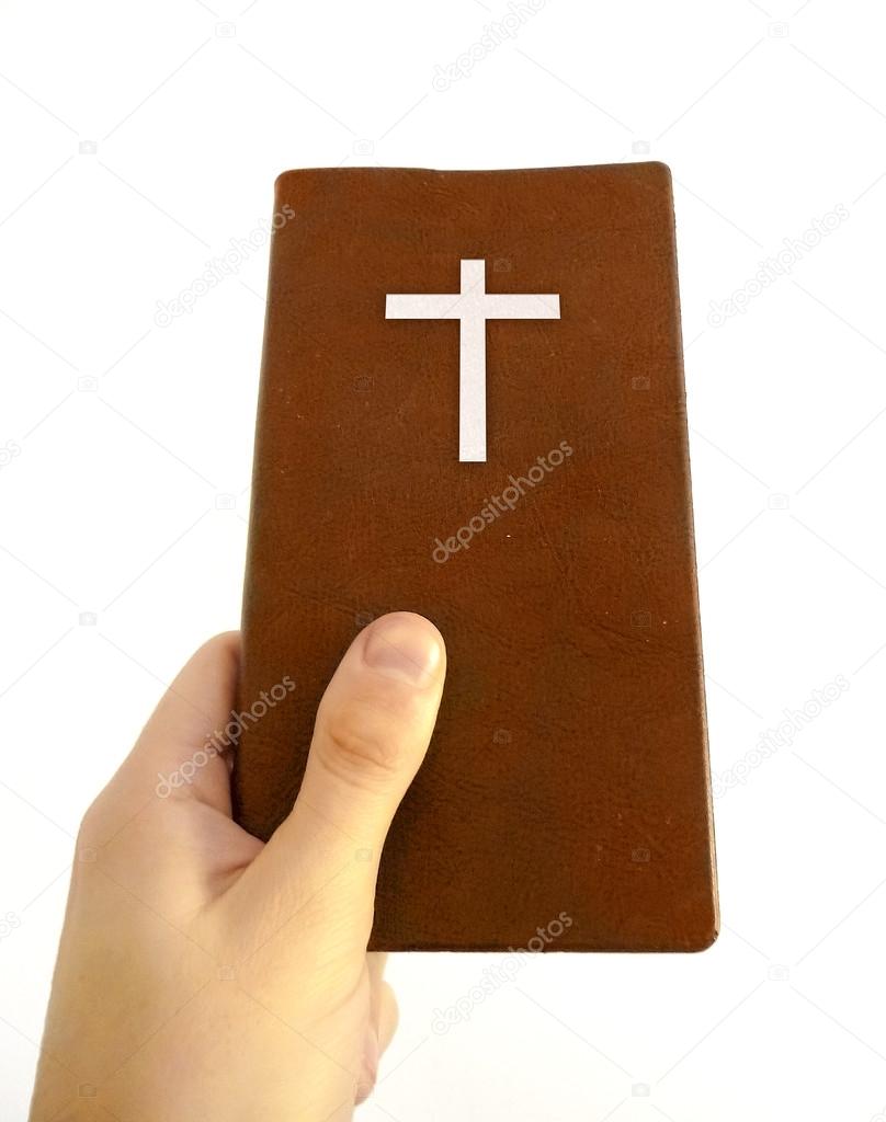 Hand Holding a Christian Book