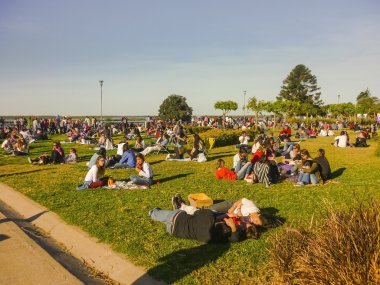 Crowd of People Enjoying a Sunny Sunday at Park clipart