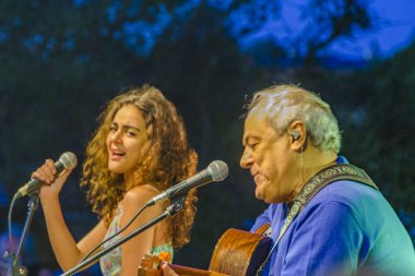 MALDONADO, URUGUAY, JANUARY - 2022 - Toquinho ve Camilla faustino Brezilyalı müzisyenler çağdaş sanat atölyesinin açılışında çalıyorlar, 