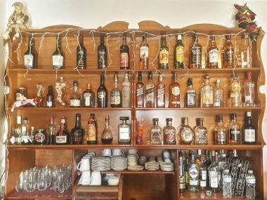 OLYMPIA, GREECE, JANUARY - 2020 - Front view vintage wooden shelf with drinks, greece