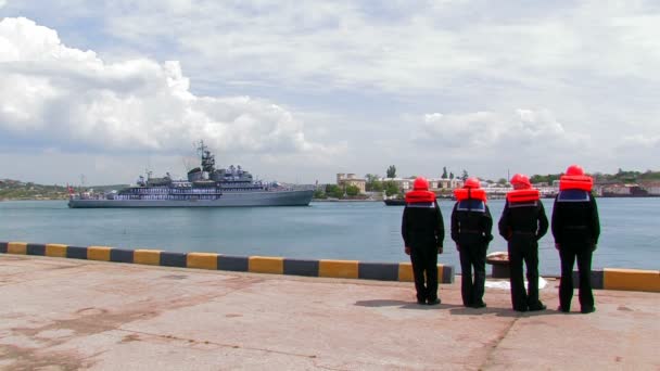 Equipa de amarração aguarda a chegada de um navio de guerra . — Vídeo de Stock
