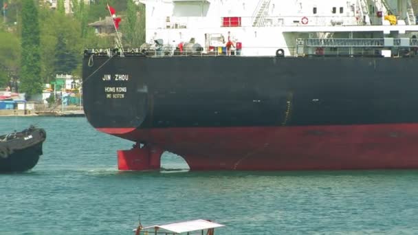 Large cargo ship and tug boat. — Stock Video