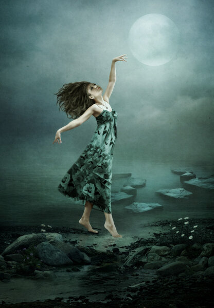 The girl on the lake in the moonlight is dancing