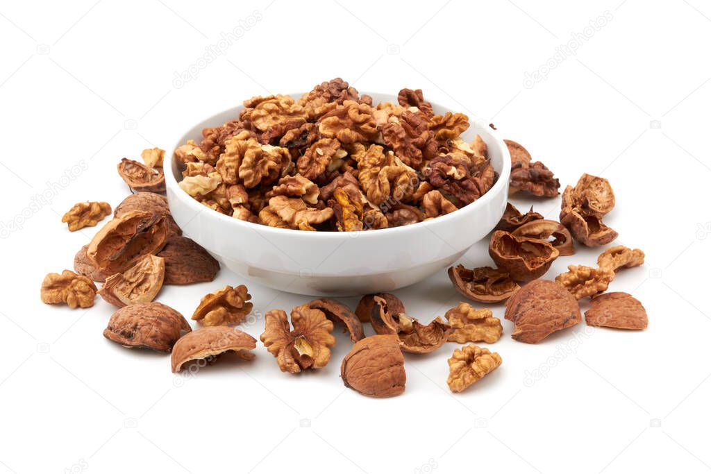 Walnuts in white bowl isolated on white background