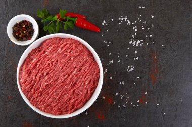 Fresh pork and beef minced meat on a black