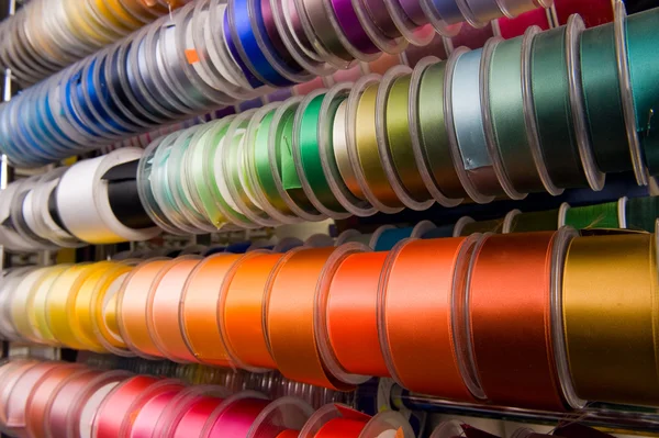 Multi-coloured ribbons on bobbins — Stock Photo, Image