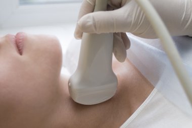 Scanning of a thyroid of woman clipart