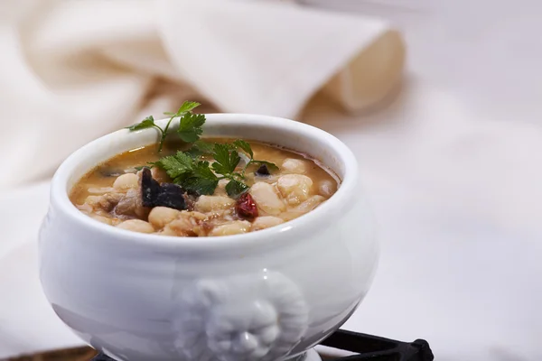 Beans cooked with mushrooms and quail Stock Image