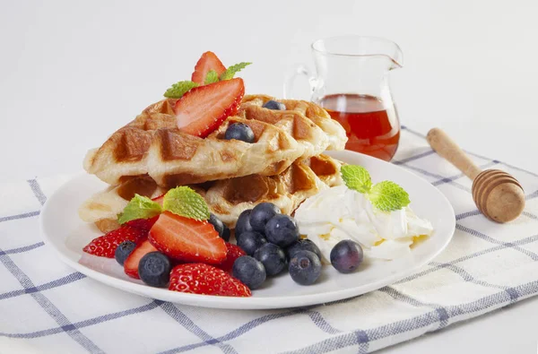 Waffles with berries and fruit. Healthy sweet summer breakfast