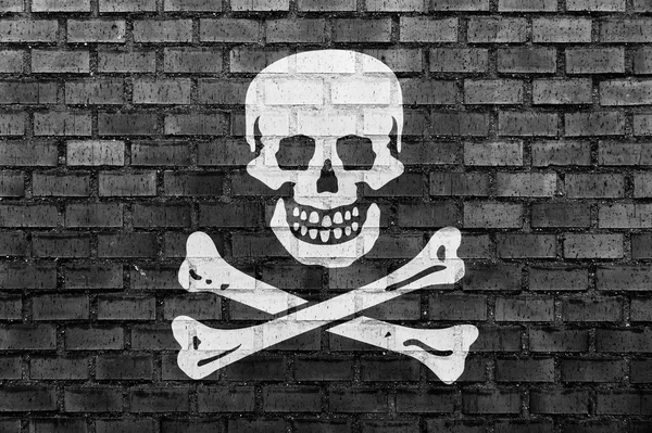 Pirate flag on a brick wall — Stock Photo, Image