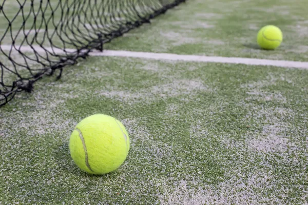 Tennis or paddle balls on synthetic grass of paddle court — Stock Photo, Image