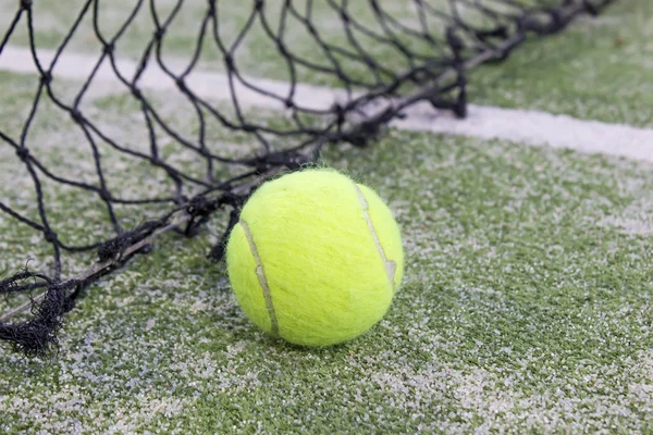 Tennis or paddle ball on synthetic grass of paddle court — Stock Photo, Image