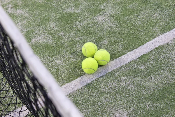 Tennis or paddle balls on synthetic grass of paddle court — Stock Photo, Image