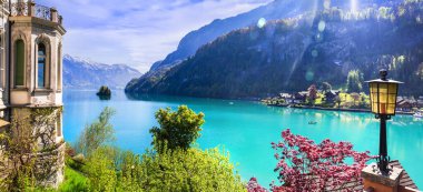 Stunning idylic nature scenery of lake Brienz with turquoise waters. Switzerland, Bern canton. Iseltwald village surrounded turquoise waters  clipart