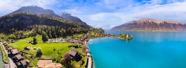 Stunning idylic nature scenery of lake Brienz with turquoise waters. Switzerland, Bern canton. Iseltwald village surrounded turquoise waters ,aereal view clipart