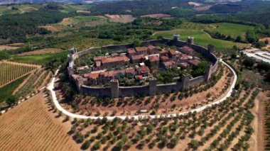 Aerial drone view of fortified medieval town and castle Monteriggioni in Tuscany, Siena province, Italy