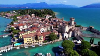 Scenic lake Lago di Garda aerial drone view of Sirmione town and medieval castle Scaligero. Italy, Lombardy