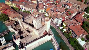 Scenic lake Lago di Garda aerial drone view of Sirmione town and medieval castle Scaligero. Italy, Lombardy
