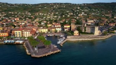 Scenic lake Lago di Garda. aerial video of Castelletto di Brenzone - medieval village and castle. Italy, Verona province