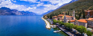 Scenic Lake Lago di Garda, Italy, aerial view of fishing village with colorful houses and boats - Castelletto di Brenzone.