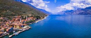 Scenic Lake Lago di Garda, Italy, aerial view of fishing village with colorful houses and boats - Castelletto di Brenzone. 