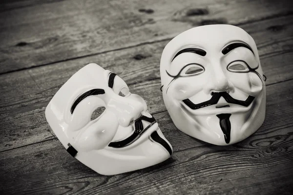 Anonymous mask on wood background — 스톡 사진