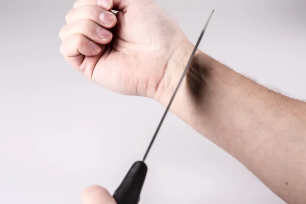 Close up of a suicidal man hand on isolated white background — Stock Photo, Image