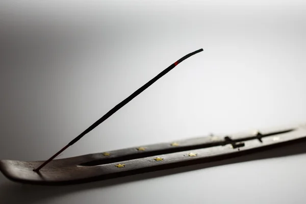 Incense stick on a wooden support on a white background — Stock Photo, Image