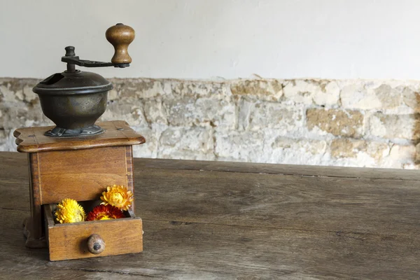 Vintage wooden coffee mill grinder with yellow flowers in open drawer — Stock Photo, Image