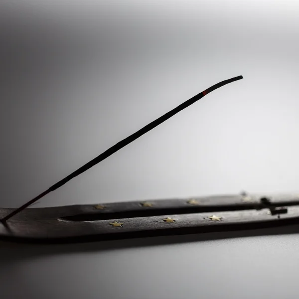 Incense stick on a wooden support on a white background — Stock Photo, Image