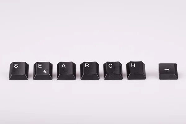 Pesquisa de texto formada com teclas de teclado do computador no fundo branco — Fotografia de Stock