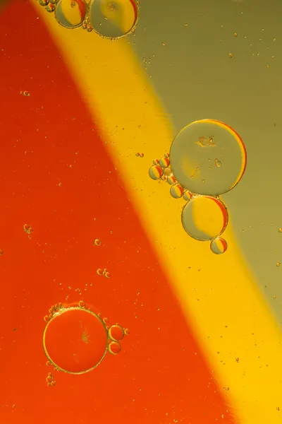 Капли масла на поверхности воды — стоковое фото