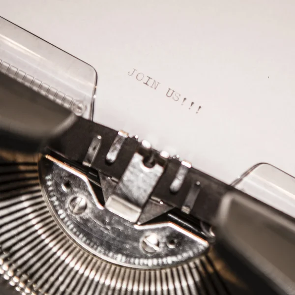 Old typewriter with text join us — Stock Photo, Image